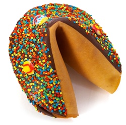 Dark Chocolate covered giant fortune cookie with birthday candies and bright confetti sprinkles