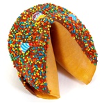 Milk Chocolate covered giant fortune cookie with birthday candies and bright confetti sprinkles