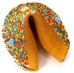 White Chocolate covered giant fortune cookie with birthday candies and bright confetti sprinkles