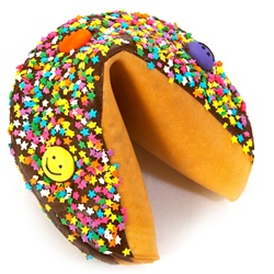 Dark Chocolate covered giant fortune cookie decorated with colorful stars and fun smiley faces