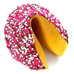 Romantic giant fortune cookie covered in dark chocolate and decorated with cute pink and white hearts.
